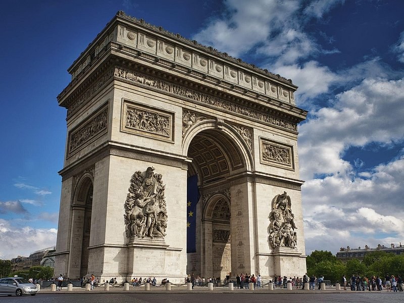 The Arc de Triomphe in Paris under a summer sky