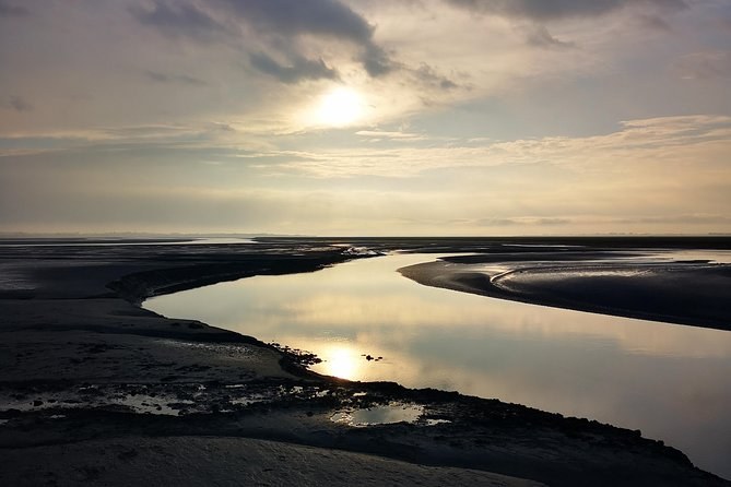 The channels of the bay of Mont-Saint-Michel shining at sunset
