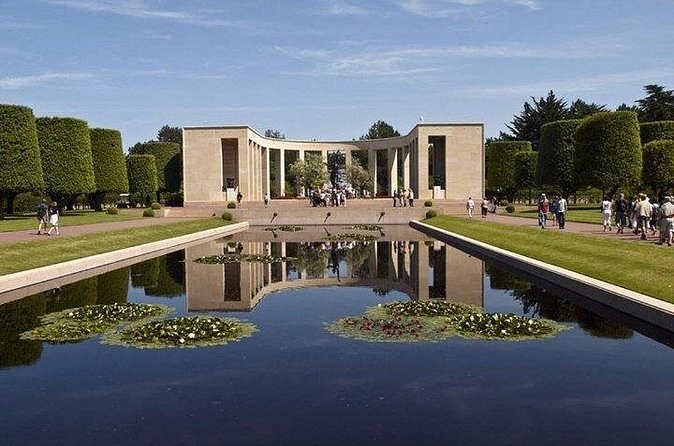 A stone memorial colonnade at the end of a long reflecting pool