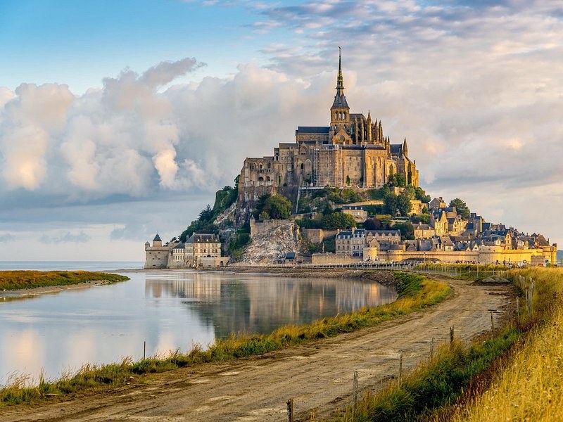 Mont-Saint-Michel and its abbey above the bay, seen from the road across the salt meadows