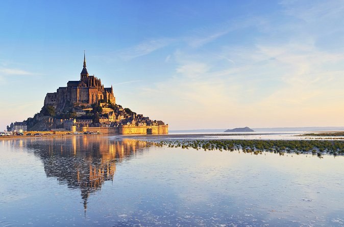 Mont-Saint-Michel reflected in the wet sand of the bay at low tide
